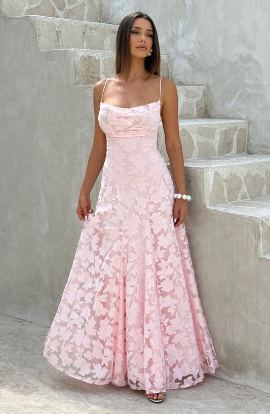 Full-length pink floral maxi dress with spaghetti straps and ruched bodice, standing by concrete steps.