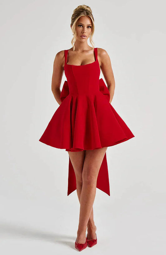 Front view of an Amber Bow Mini Dress in bright red with a large back bow, square neckline, and flared skirt.