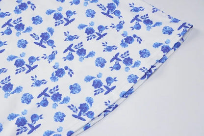 Fabric close-up of the Brooke Floral Maxi Dress, showing the vibrant blue floral pattern against the white material.