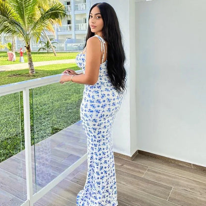 Back view of the Brooke Floral Maxi Dress, showcasing the blue floral pattern and flattering fit as the woman looks over her shoulder.