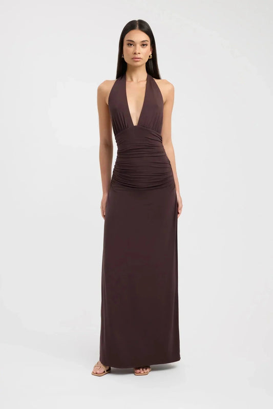 Front view of a dark brown ruched maxi dress with a deep V-neck halter top and a long, flowing skirt.
