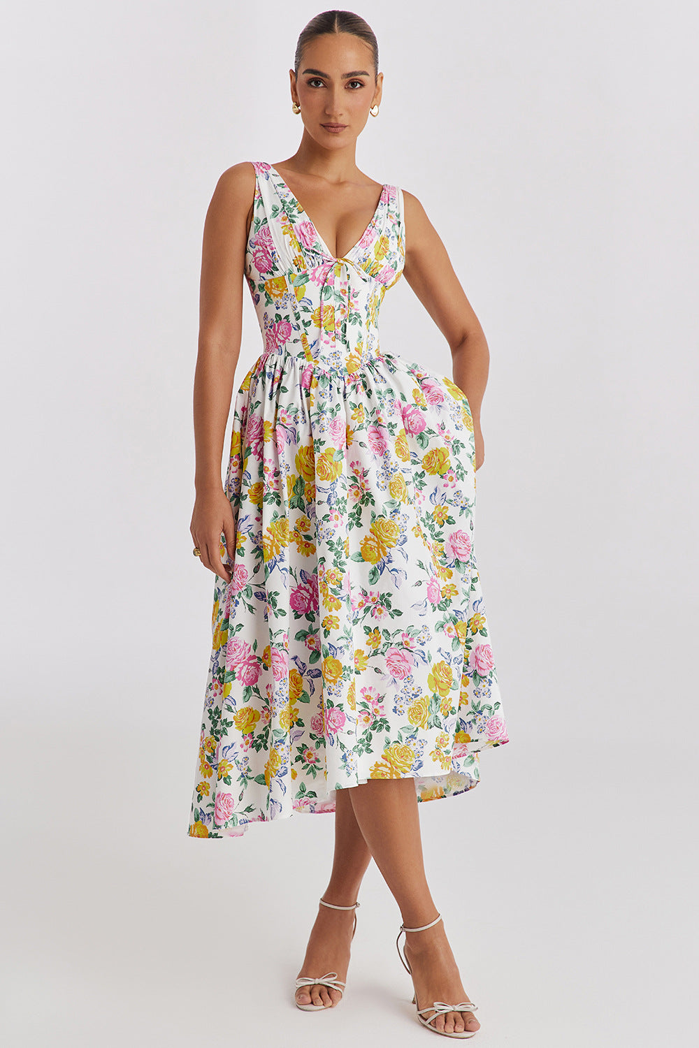 Front view of the white Dahlia Floral Midi Dress with vibrant pink and yellow rose print, deep V-neck, and pockets.