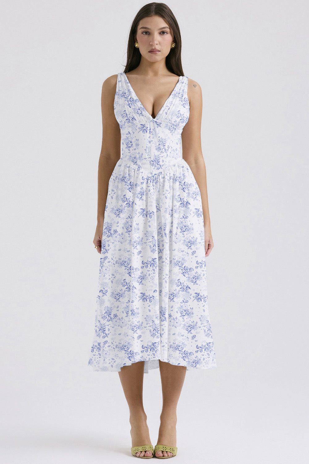 Front view of the white and blue floral midi dress, featuring a classic blue toile-inspired print and deep V-neckline.