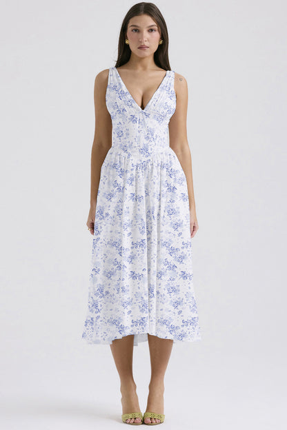 Front view of the white and blue floral midi dress, featuring a classic blue toile-inspired print and deep V-neckline.