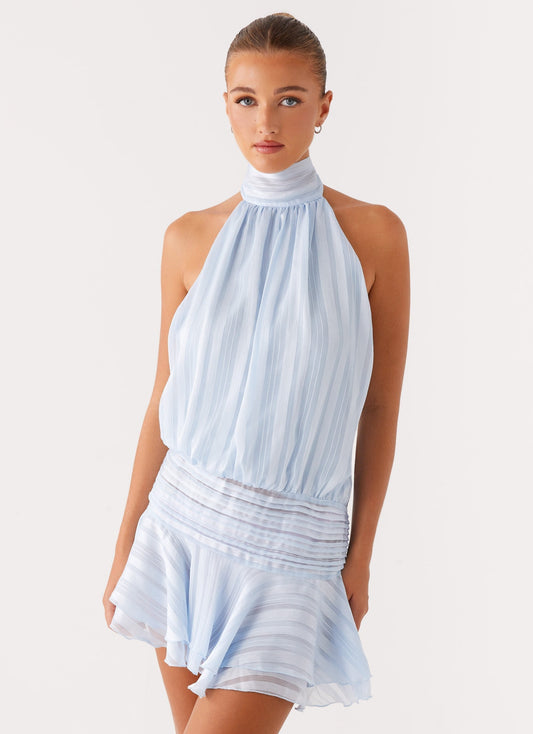 Light blue Daniela pleated mini dress with halter neck and shirred waist, featuring subtle vertical stripes.