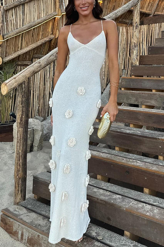 White Emilia Floral Maxi Dress with delicate 3D floral appliques and thin spaghetti straps, standing on wooden steps.