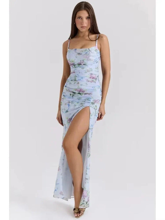 Light blue floral maxi dress with spaghetti straps and ruched detailing, thigh-high slit, and delicate purple flowers.