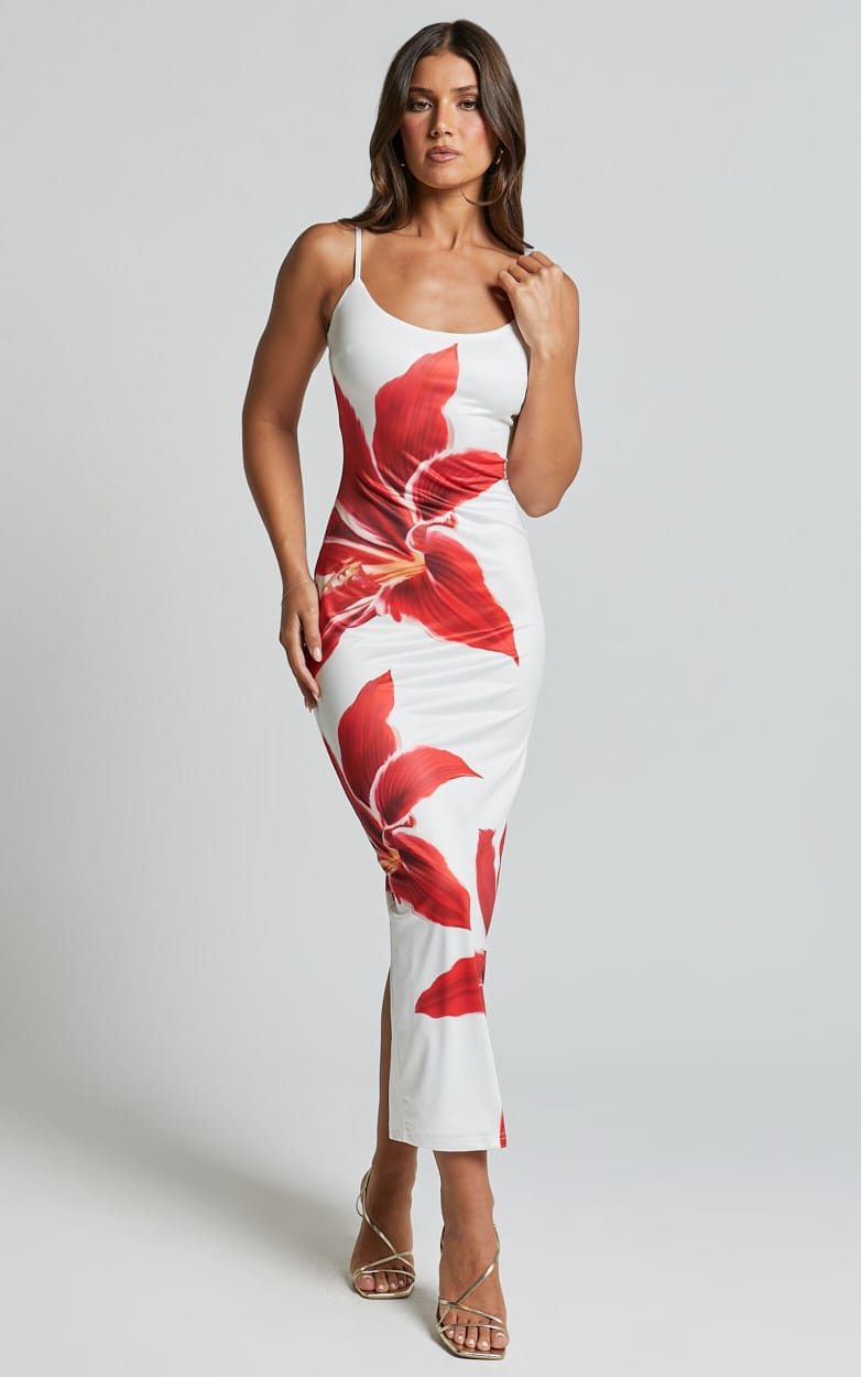 Full front view of the Harper floral midi dress, white with bold red lily pattern, worn with gold heels.