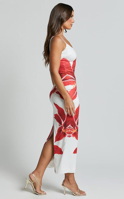 Side view of the Harper floral midi dress, showing the red lily print and a subtle side slit.