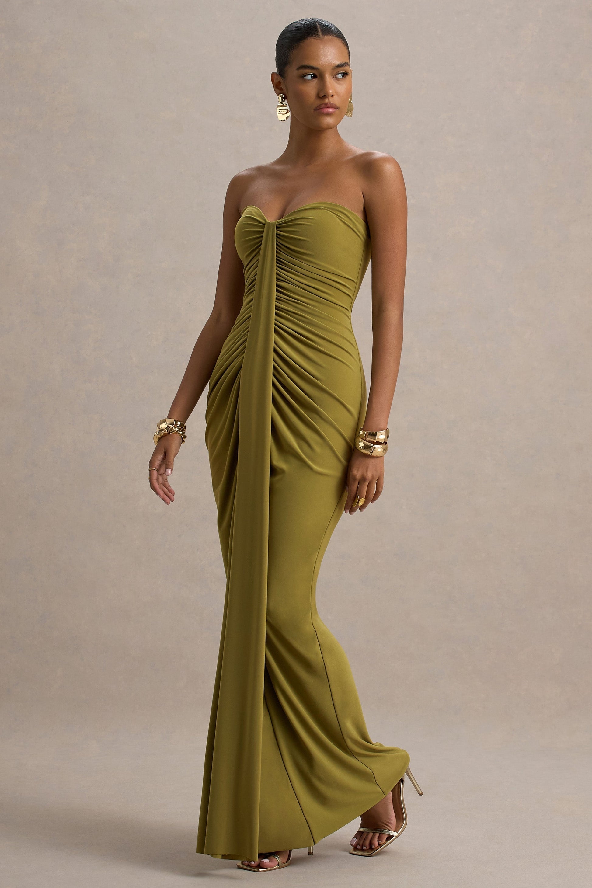 Side view of an olive green strapless ruched maxi dress, showing the flowing skirt and fitted bodice.