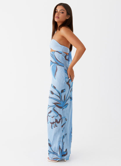 Side profile of Lyra Floral Maxi Dress in light blue with dark blue floral print, showing tie-back detail.