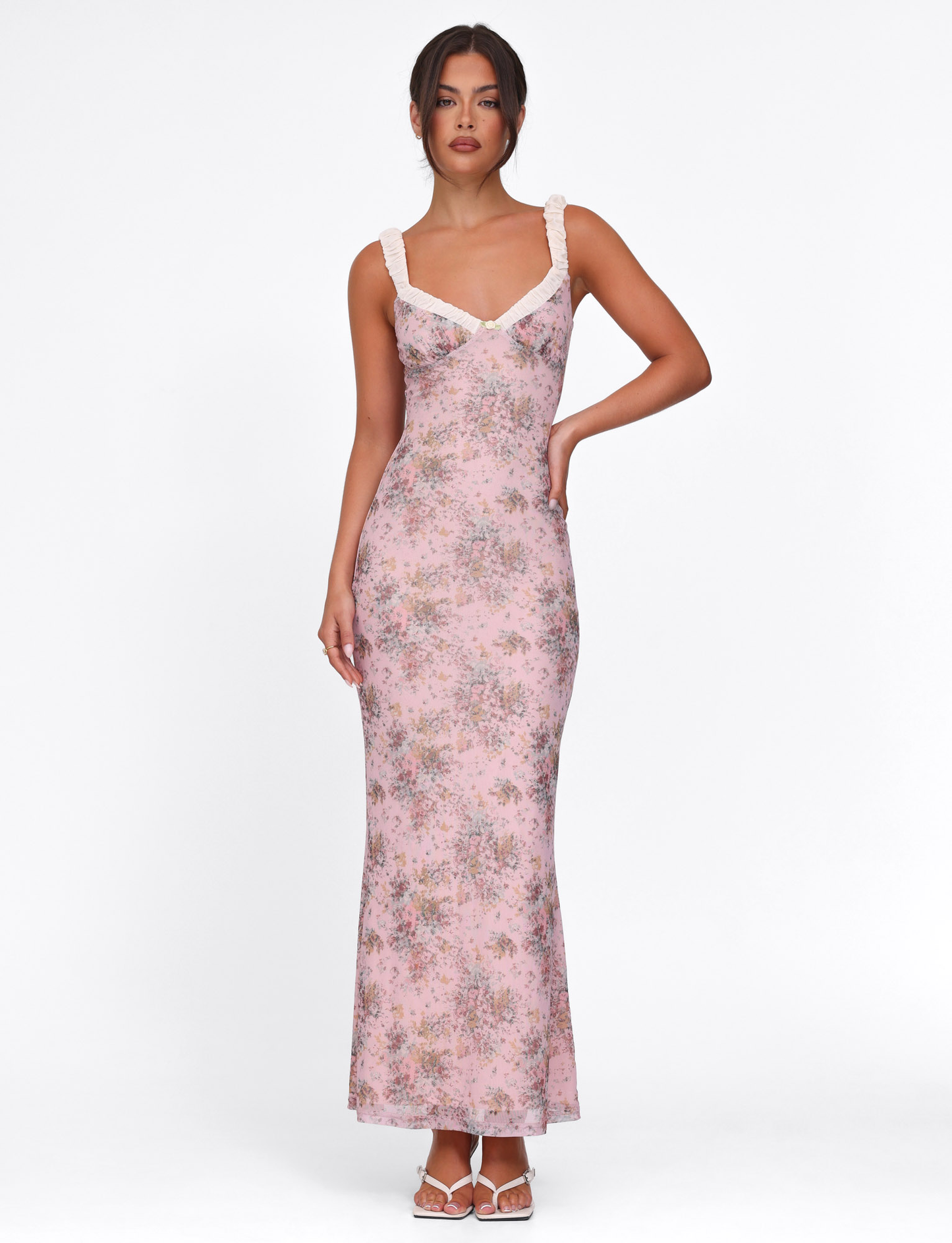 Full-length view of the pink floral maxi dress featuring white ruffled straps and a subtle v-neck design, elegant fit.