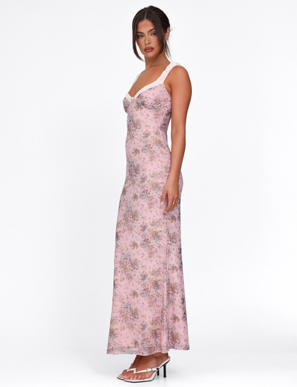 Side profile of the pink floral maxi dress, showcasing the slim silhouette and delicate white ruffled shoulder straps.