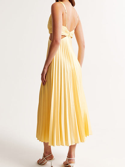 Back view of the light yellow Maria Pleated Maxi Dress, showcasing the delicate spaghetti straps and the continuous pleating down the skirt.