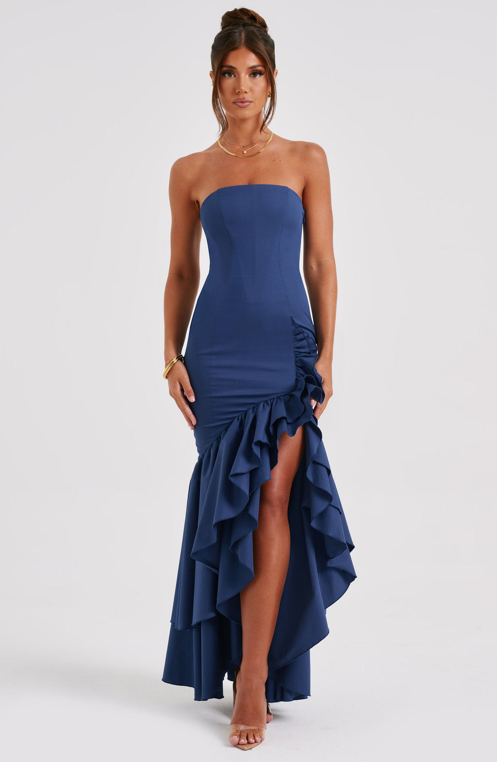 Marlowe Ruffle Maxi Dress in a deep navy blue, featuring a strapless design, a fitted silhouette, and a cascading high-low ruffle skirt with a thigh-high slit.