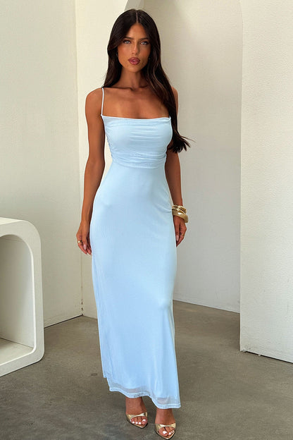 Full view of the light blue Mina Lace Maxi Dress, showing the form-fitting design and flowing skirt with gold accessories.