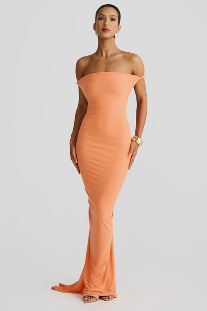 Front view of the Paulina backless maxi dress in a soft peach color, styled off-the-shoulder for an elegant look.