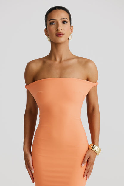Close-up front view of a peach Paulina backless maxi dress with an off-the-shoulder neckline and smooth, fitted bodice.