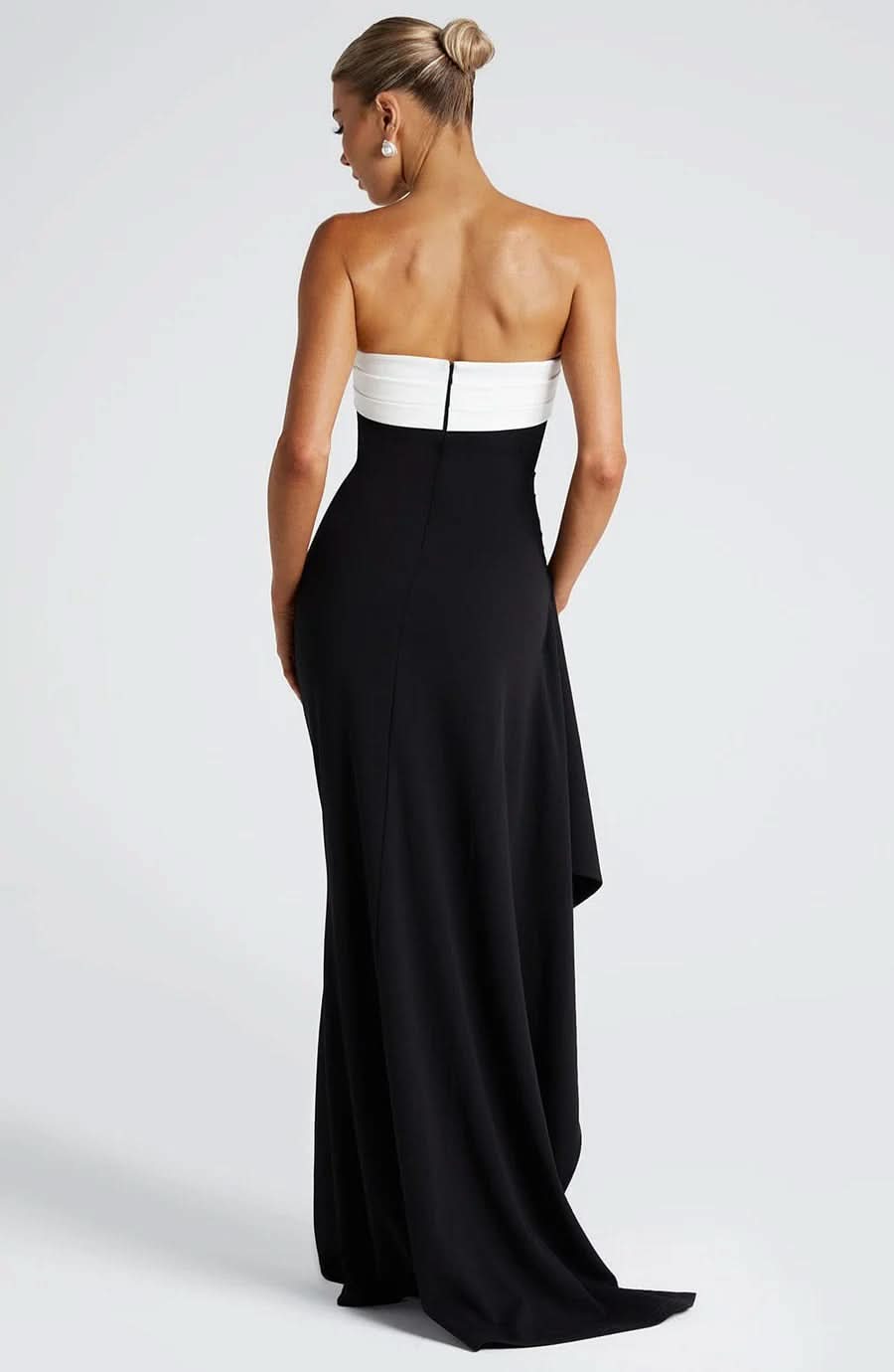 Back view of the black and white strapless ruched maxi dress, showing the contrasting colors and elegant drape.
