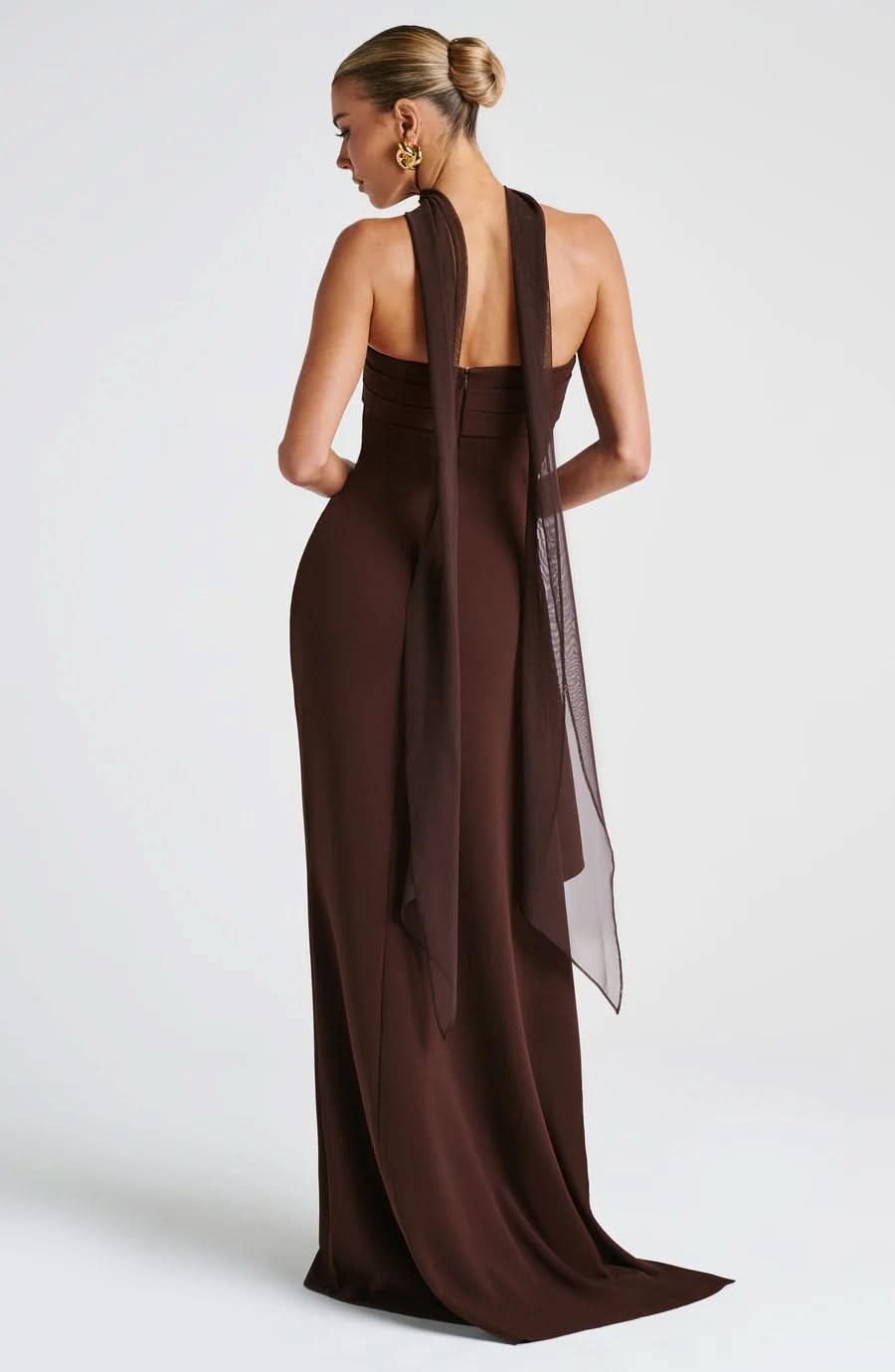 Back view of the brown Piper Ruched Maxi Dress, featuring a long, flowing sheer scarf detail from the neckline.