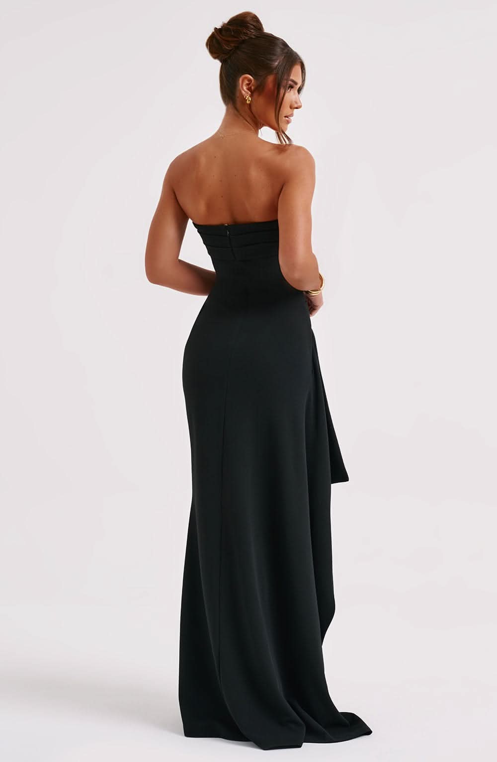 Back view of a black strapless maxi dress, showing the fitted bodice and flowing skirt with subtle ruching.