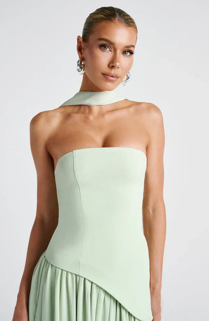 Close-up of the light green strapless bodice and choker-style neck scarf of the Rhea asymmetrical maxi dress.