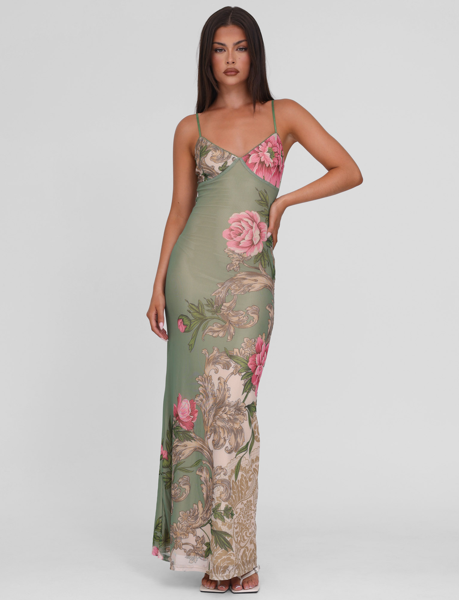 Olive green floral maxi dress styled for cocktail wear — model wearing heels