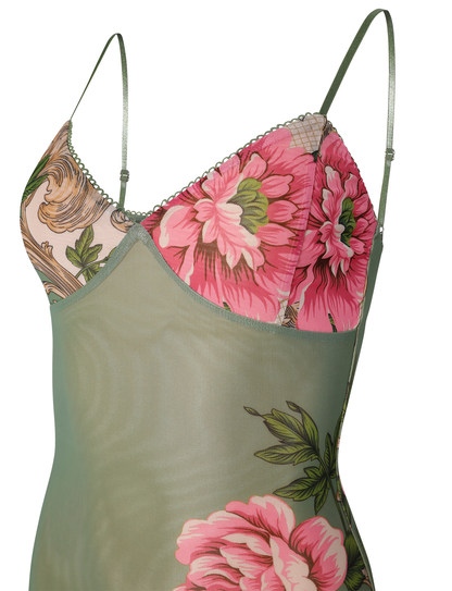 Detailed close-up of the bust of the green floral mesh maxi dress, showing the pink floral print and delicate trim.