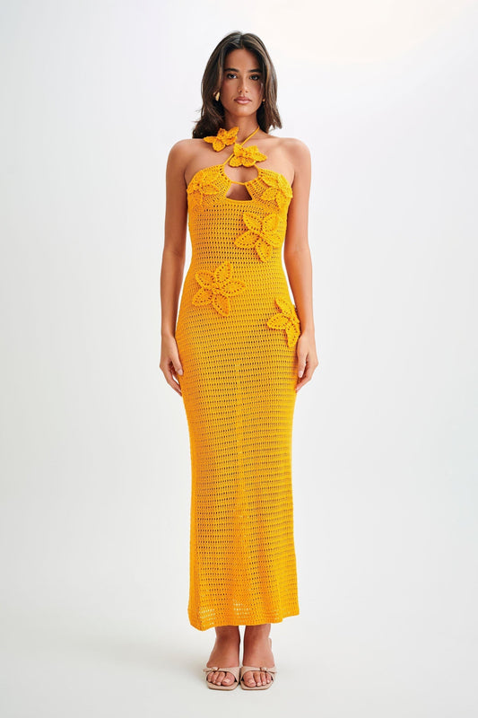 Front view of a yellow crochet maxi dress with floral appliques and a halter neckline, perfect for a wedding or summer event.