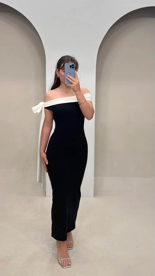Black off-shoulder maxi dress with a prominent white bow on one shoulder for women