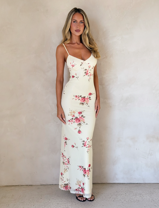 White floral maxi dress with spaghetti straps and body-hugging silhouette — front view showing full length.